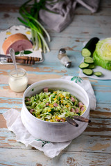 cabbage ham salad in ceramic bowl. selective focus