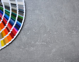 Color palette guide, fan, catalogue on grey background. Color swatch on conсrete texture