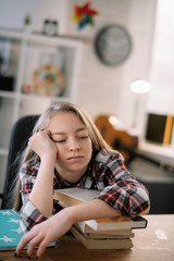 Cute little girl. Tired schoolgirl learning. 