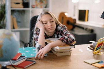 Cute little girl. Tired schoolgirl learning. 