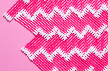 Hygiene: multi-colored plastic cotton buds lie on the yak background