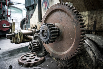Rusting cogs and machinery at abandoned factory
