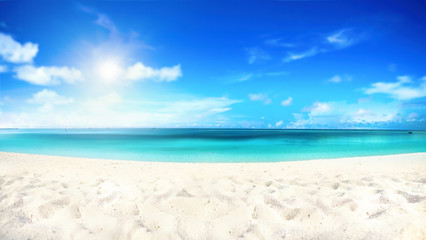 Fototapeta na wymiar Beautiful beach with white sand, turquoise ocean water and blue sky with clouds in sunny day. Natural background for summer vacation, soft focus.