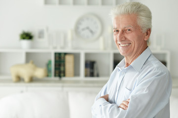 Portrait of happy senior man at home