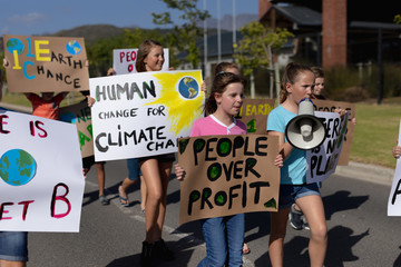 Group of elementary school pupils walking on a protest march
