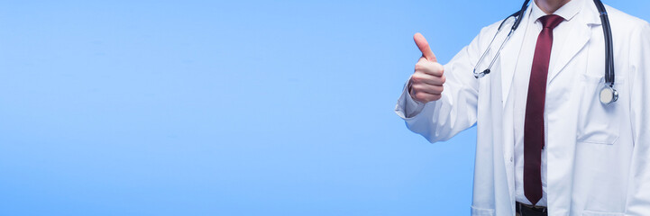 Doctor hand giving thumbs up over blue background. Wide medical banner