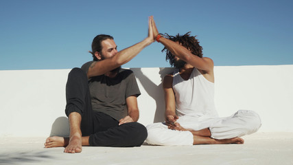 Multicultural friends smoke weed and high five each other rooftop shaky footage