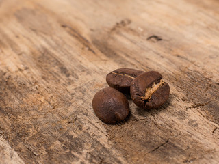 roasted coffee beans on wooden background. 