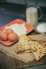 cooked pancakes, ingredients and cooking utensils for making pancakes,crêpe