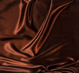 Abstract brown wavy textile silk background with chocolate, cocoa, coffee color