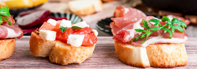 Banner of Set of bruschetta on wooden background. .