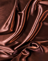 Abstract brown wavy textile silk background with chocolate, cocoa, coffee color