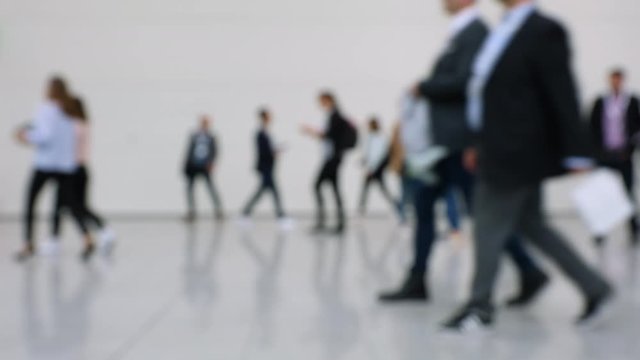 Blurred crowd of people passing close by at a business fair