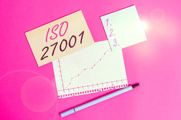 Writing note showing Iso 27001. Business concept for specification for an information security analysisagement system Stationary and note paper math sheet with diagram picture on the table