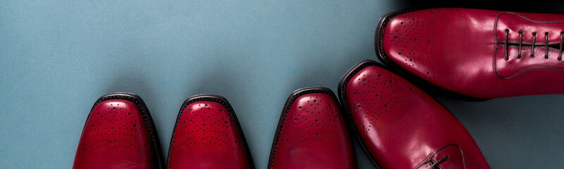 Banner of Red oxford shoes on blue background. Three pair brogues.