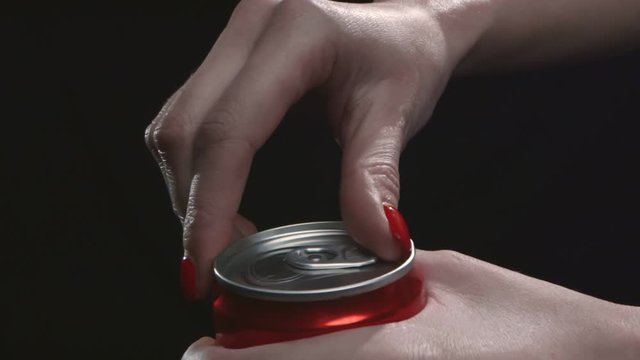 Close Up Of Female Hand With Red Nails Opening Red Can With Drink Isolated