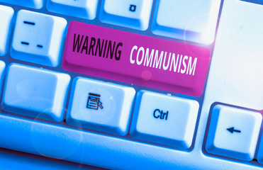 Conceptual hand writing showing Warning Communism. Concept meaning economic system where the group...