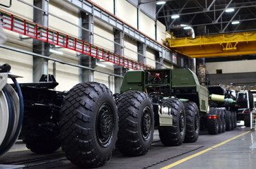 Inside of the Wheel Tractor Plant . Industrial workshop for the production of military trucks. Factory of the manufacturing wheel chassis and vehicles which carries heavy loads