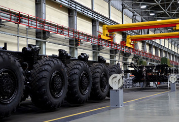 Super heavy duty machine with more wheels for ballistic missile transport and non-standard cargo. Industrial workshop for the production of military trucks, wheel chassis and vehicles