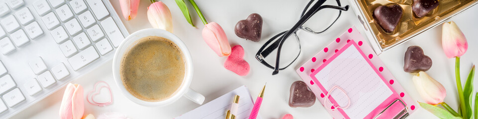 Modern office desk workspace with laptop keyboard, notebook and stationery. Springtime and valentine day pastel workspace background. Flat lay lifestyle with copy space