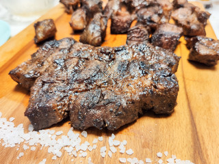 entrecote beef steak sliced with salt close up on a modern wooden cutting Board.