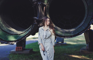 Fashion in military. Woman model wearing military uniform with aircraft background 