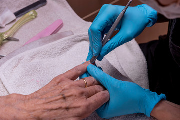Close-up of the hands of an elderly woman, who are doing manicure