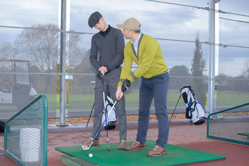 the beginner hitting golf ball