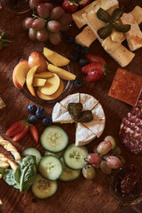 Food plate with various snacks, cheese, fruit and vegetables