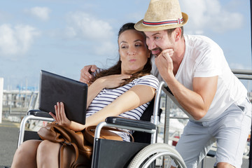Plakat couple in wheelchair taking a wacky selfie tongue out