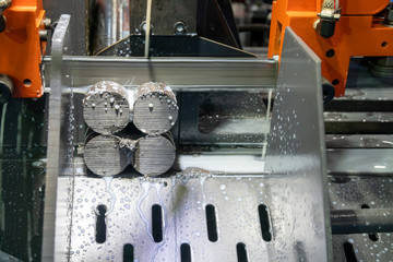 The operation of band saw machine cutting the metal rod. The ingot material preparation for machining process by automatic band saw machine.