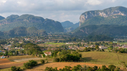 Fototapeta na wymiar vinales valley landscape with moutains, clouds, many trees and farms, cuba