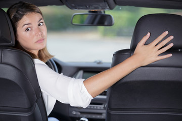 woman driving a car in reverse