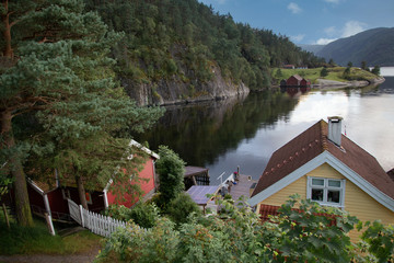 wooden houses on a mountain lake shore