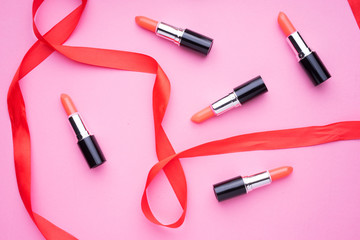 Obraz premium Creative arrangement of cosmetics products on pink background.