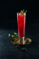 Fresh summer cocktail with ice cubes and mint on dark background