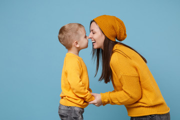 Woman in yellow clothes have fun posing with cute child baby boy 4-5 years old. Mommy little kid son isolated on blue background studio portrait. Mother's Day love family parenthood childhood concept.