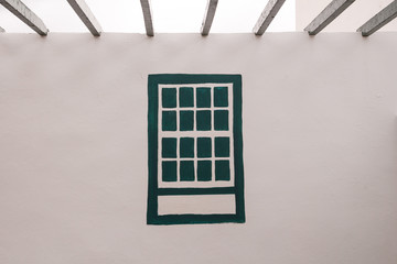 White wall and a painted window
