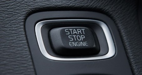 Crop shot of start stop engine button of vehicle
