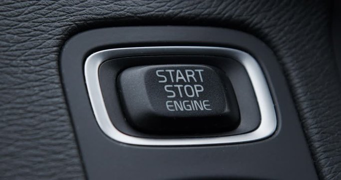 Crop shot of start stop engine button of vehicle