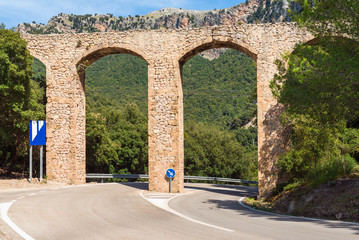 Obraz premium Old historic bridge over the road in Mallorca. Baleares, Spain