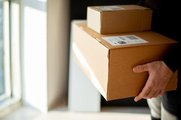 Young man carrying packages for shipment