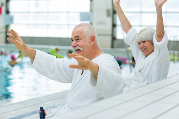 elderly couple near swimming pool