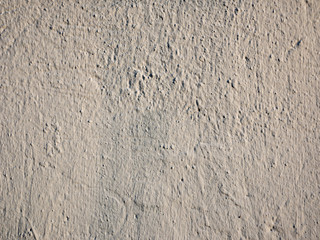 Gray abstract stucco background.. Uneven gray textured stucco on the wall. Background from brown stucco.