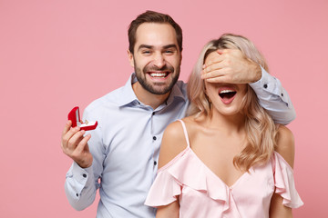 Smiling couple two guy girl in party outfit celebrating isolated on pink background. Valentine's...