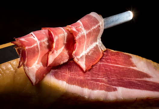 Dry Spanish ham, Jamon Serrano, Italian prosciutto crudo or Parma ham, whole leg isolated on black background