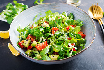 Fresh salad tomato, avocado, corn salad and chia seed. Healthy food concept. Vegetarian / vegan cuisine. Dietary food.