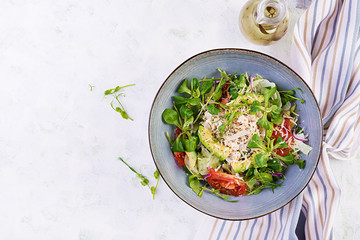 Fresh salad with chicken breast, corn salad, cucumber, avocado and tomato. Chicken salad. Italian cuisine. Healthy food concept. Top view, overhead