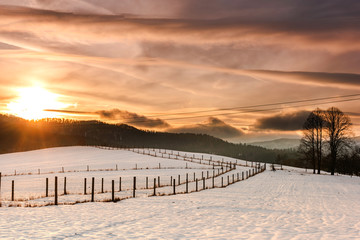 Beautiful Sunset over Snow Covered Farmland and Fields in Bieszczady, Poland