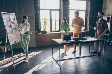 Company of four nice attractive smart clever hardworking people speaker presenter demonstrating report profit income chart plan at work place station office indoors